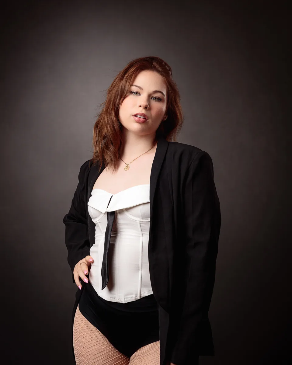 Woman in stylish black and white outfit.