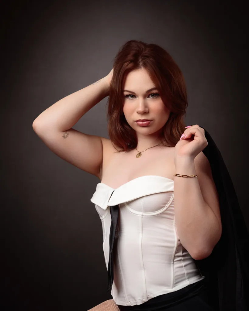 Woman in white corset with necklace and bracelet.
