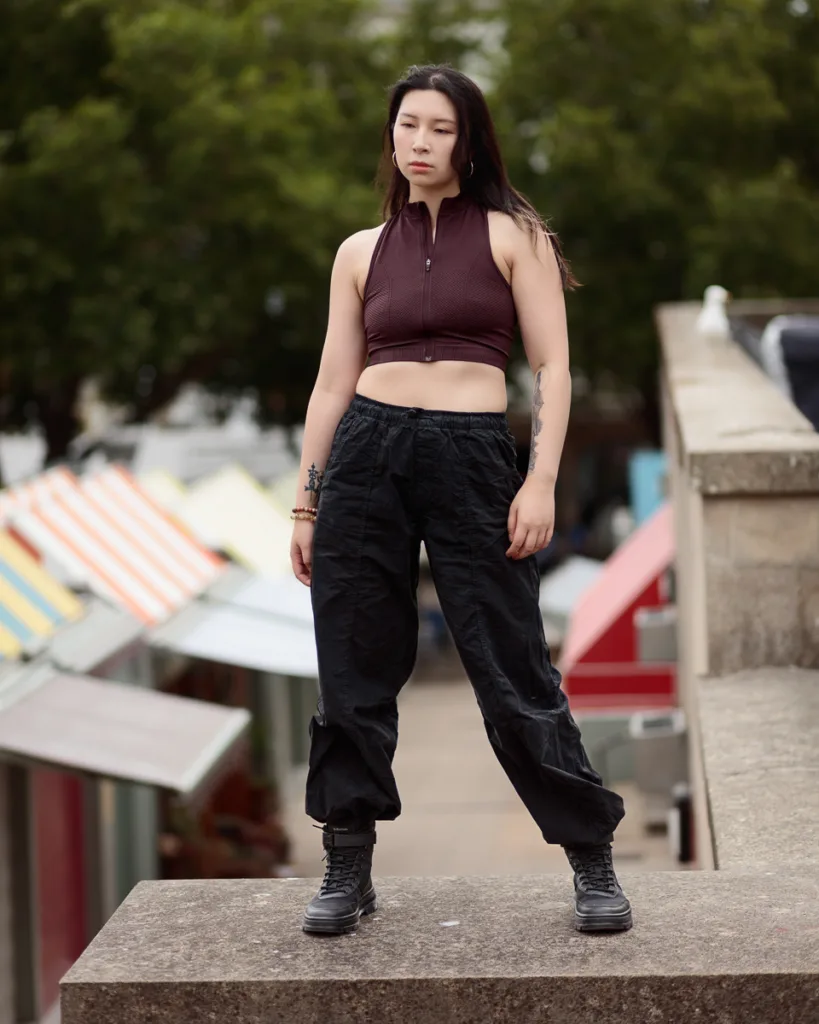 Person standing in urban area with colourful background.