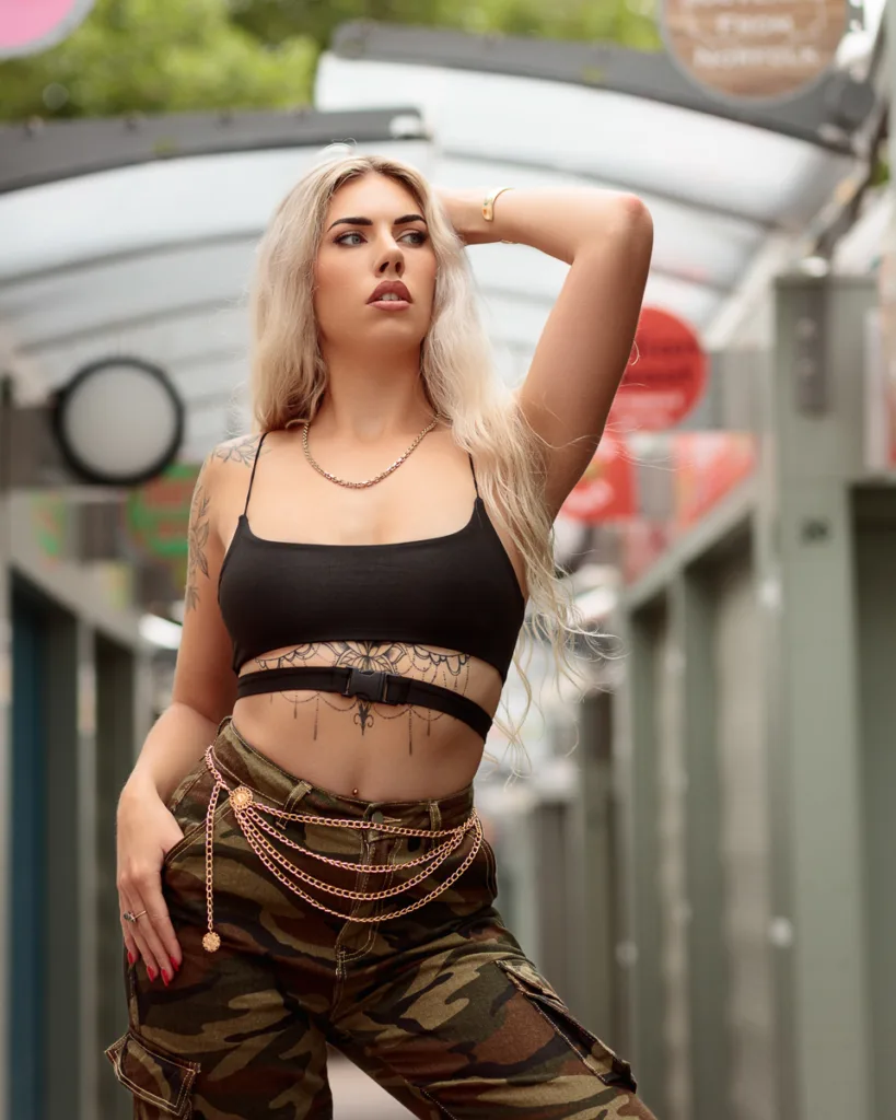 Fashionable person in camo trousers posing outdoors.