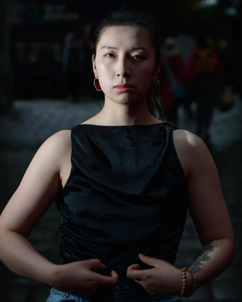 Woman in dimly lit urban street.