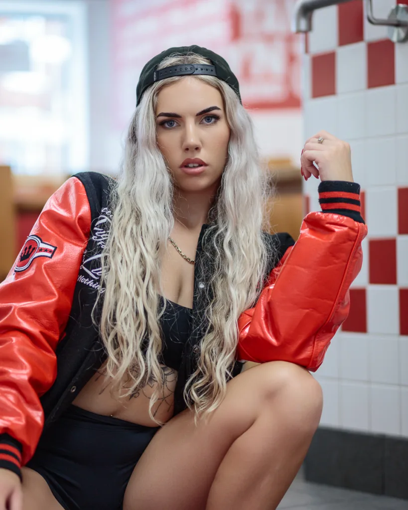 Person in cap and jacket sitting indoors