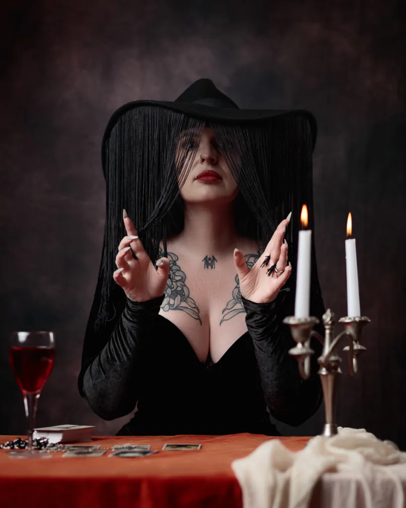 Mystical woman performing tarot reading by candlelight.