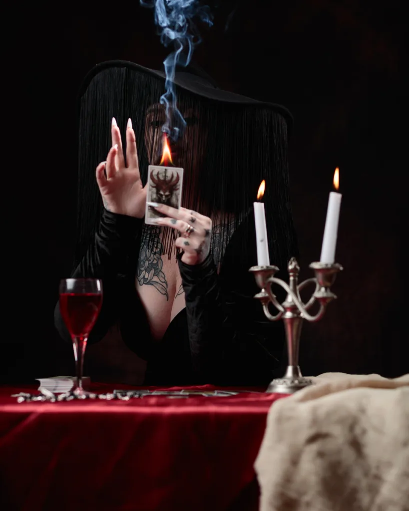 Mystic reading tarot cards with candlelight and smoke.