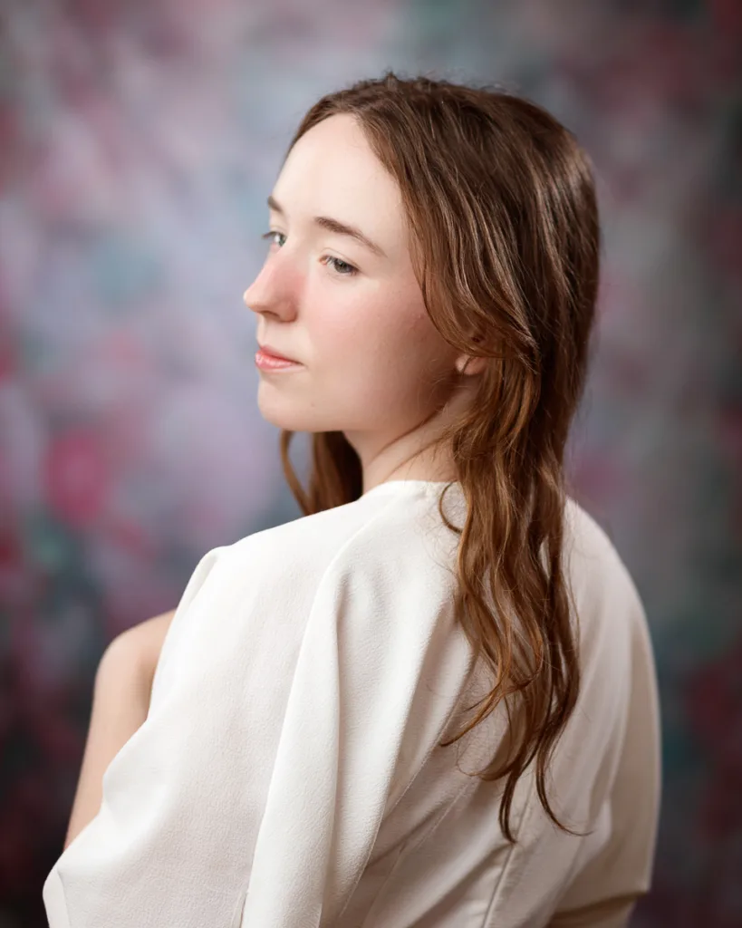 Woman posing against colourful blurred background