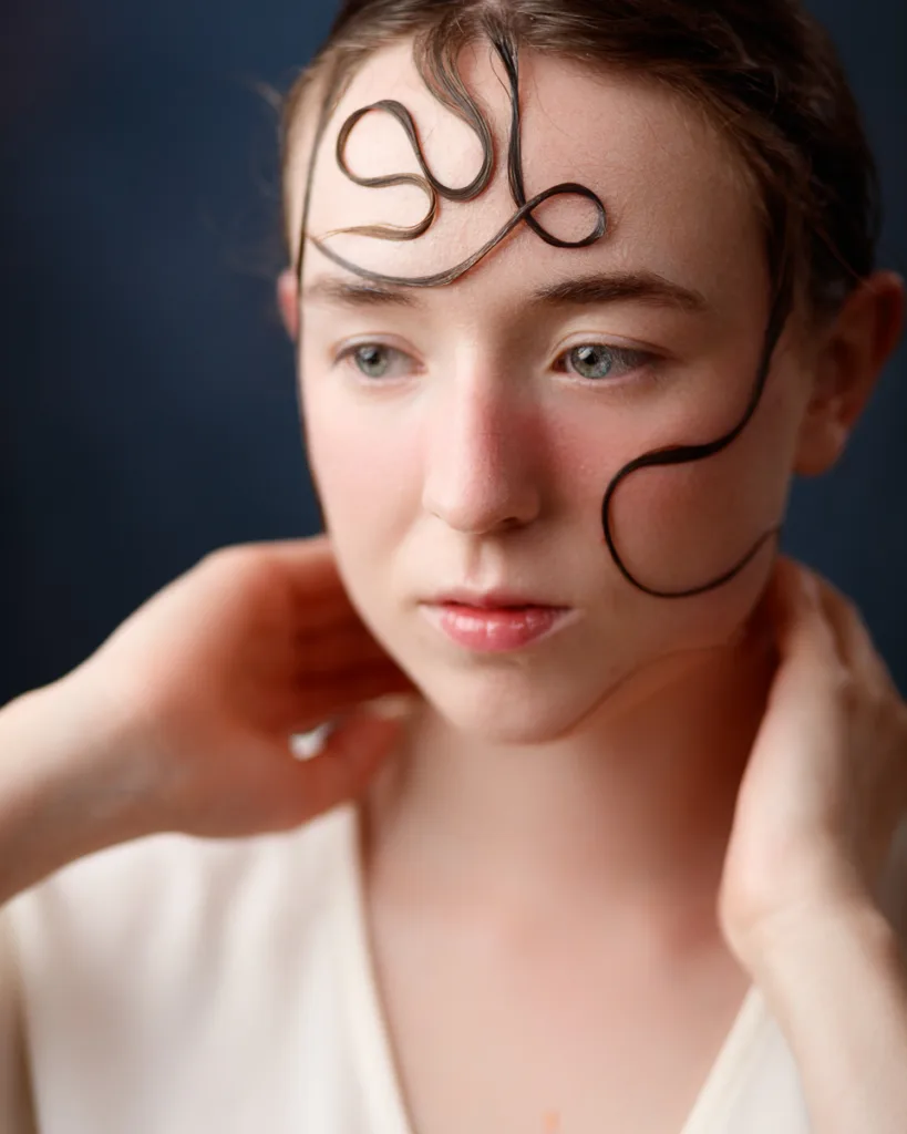 Person with artistic hairstyle on forehead