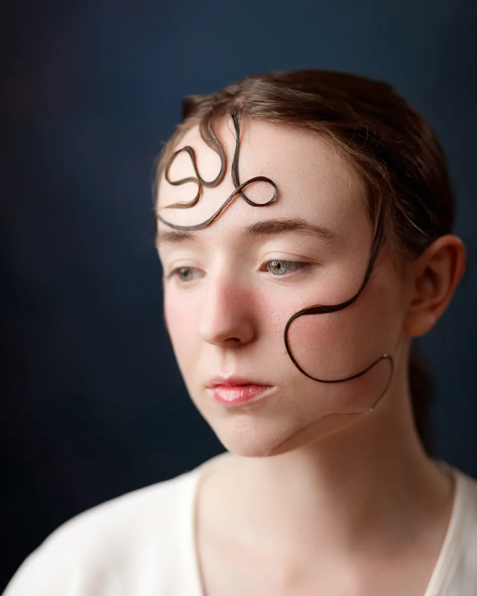 Woman with artistic hair design on face