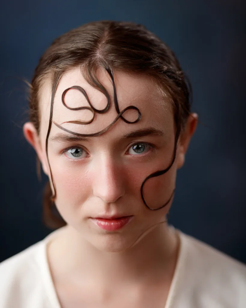 Close-up of person with creative hair arrangement.