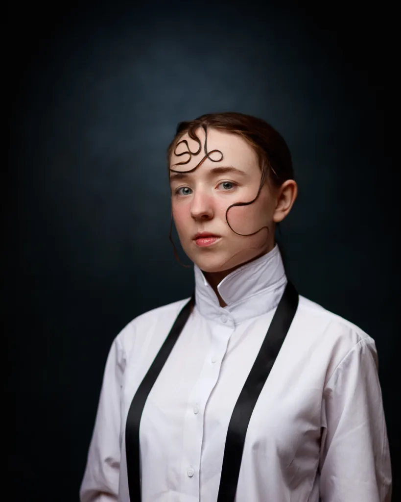 Person in white shirt with creative hair design.