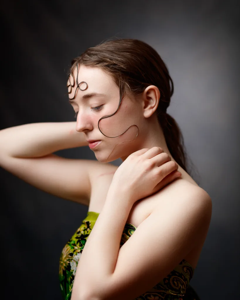 Woman with artistic makeup on a dark background.
