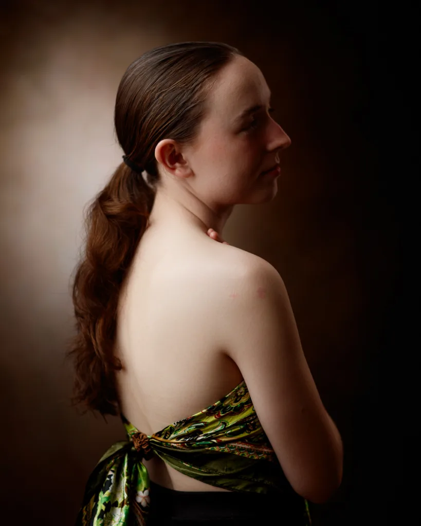 Woman in floral dress facing sideways, elegant pose