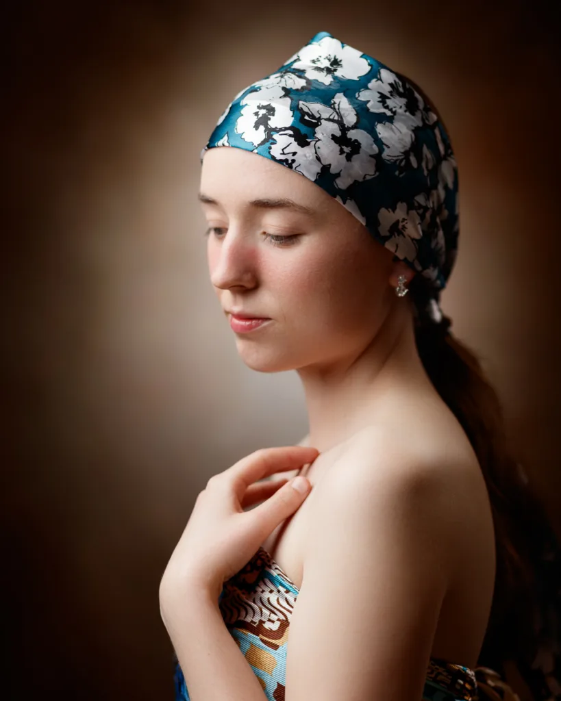 Woman wearing floral scarf, posing gracefully.
