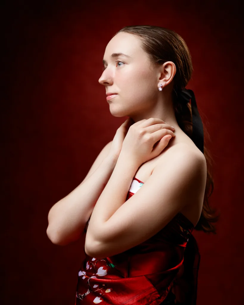 Woman in red dress with dark background