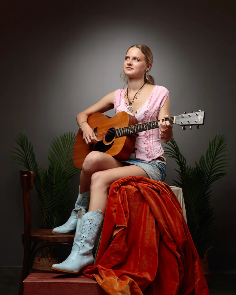 Woman plays guitar in stylish setting