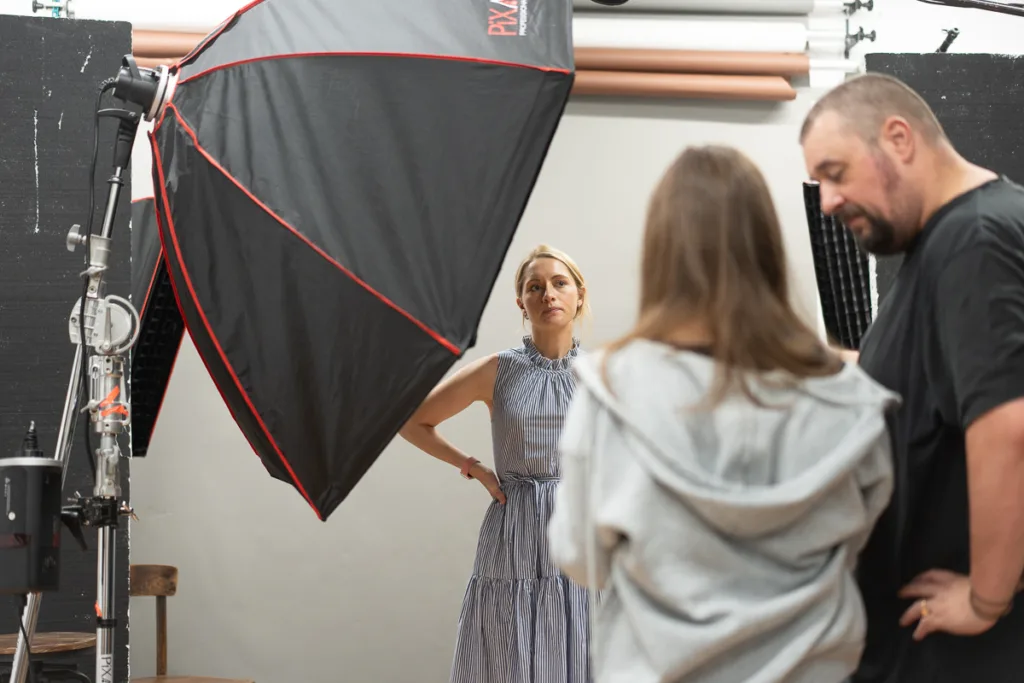 Photography studio equipment setup and crew discussion.