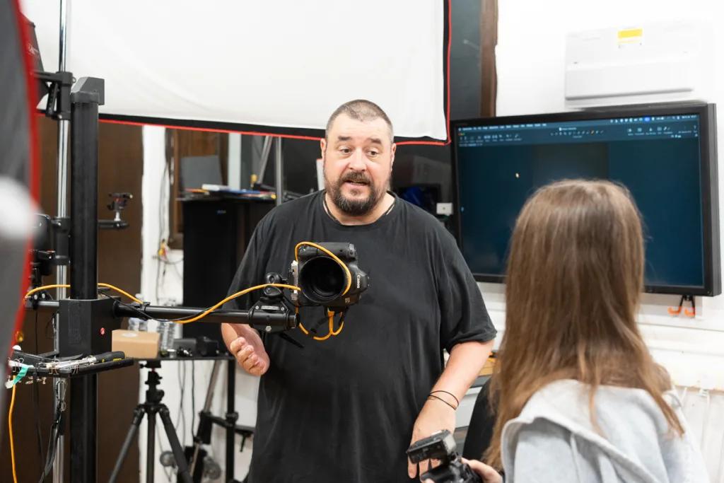 Photographer and assistant in a studio setting.