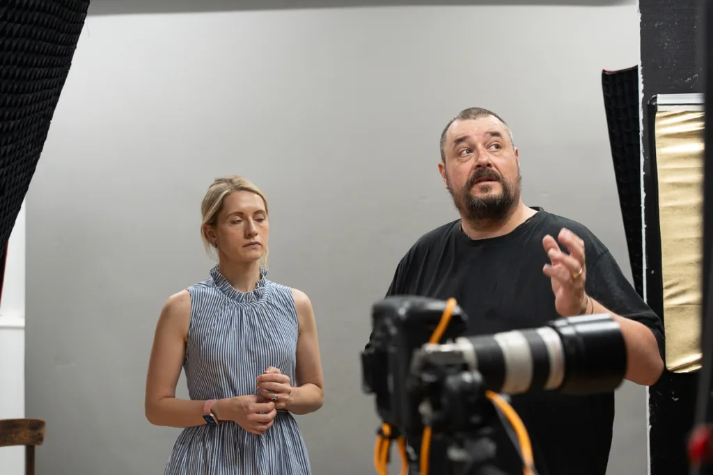 Photographer directs model in studio setup