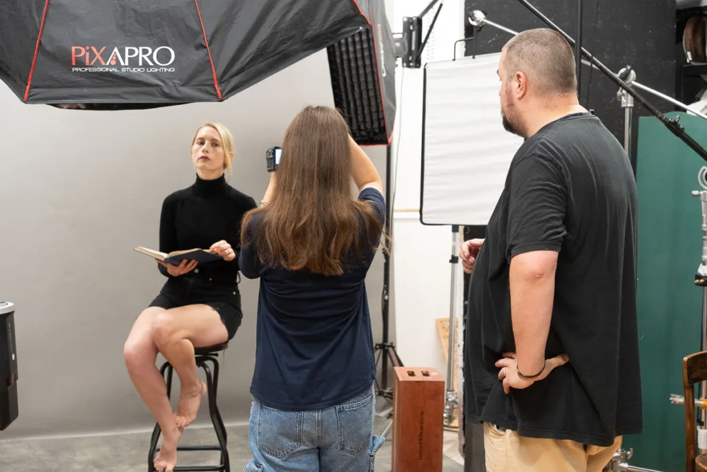 Photography studio session with model and crew.