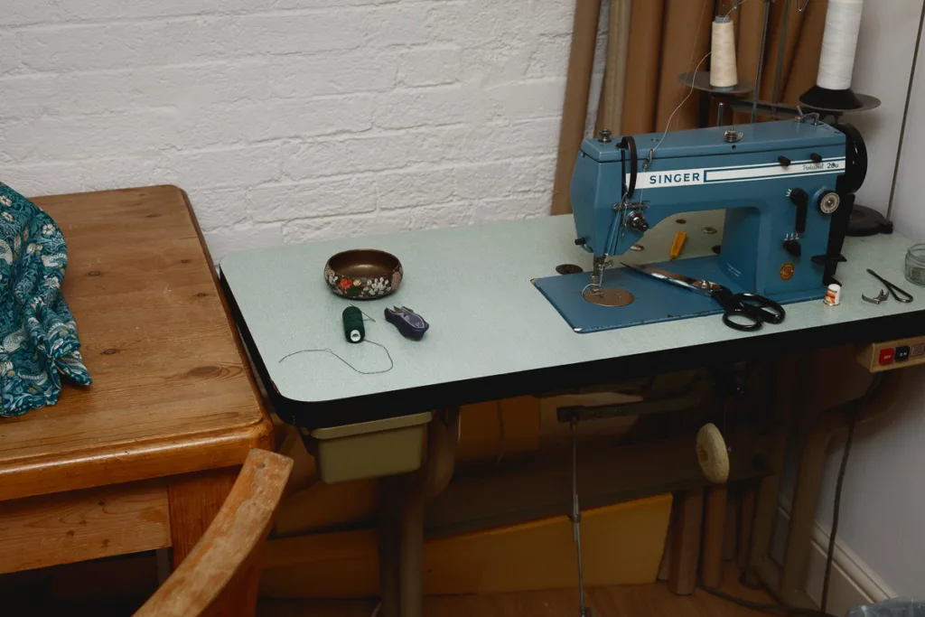 Vintage sewing machine and supplies on table