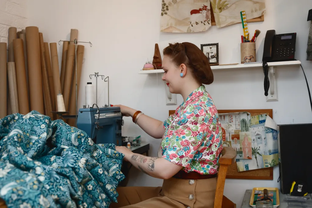 Woman sewing colourful fabric on a sewing machine.