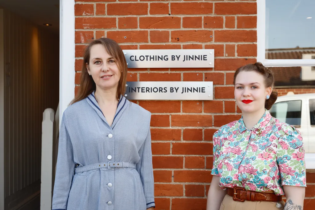 Two women outside Clothing and Interiors by Jinnie.