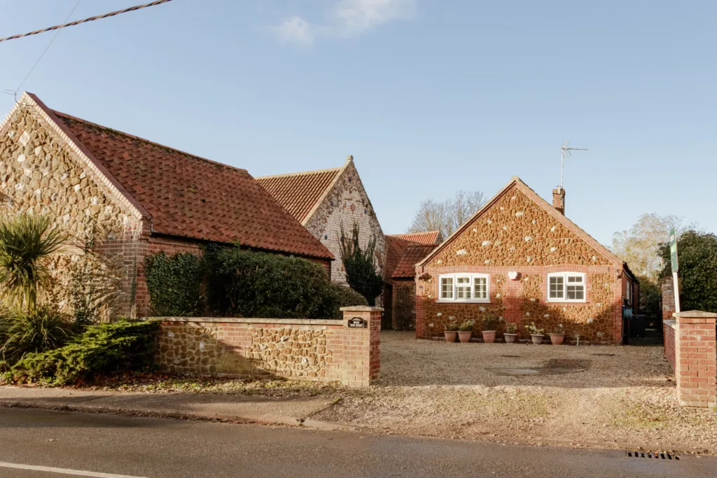 Charming brick cottages under clear sky.