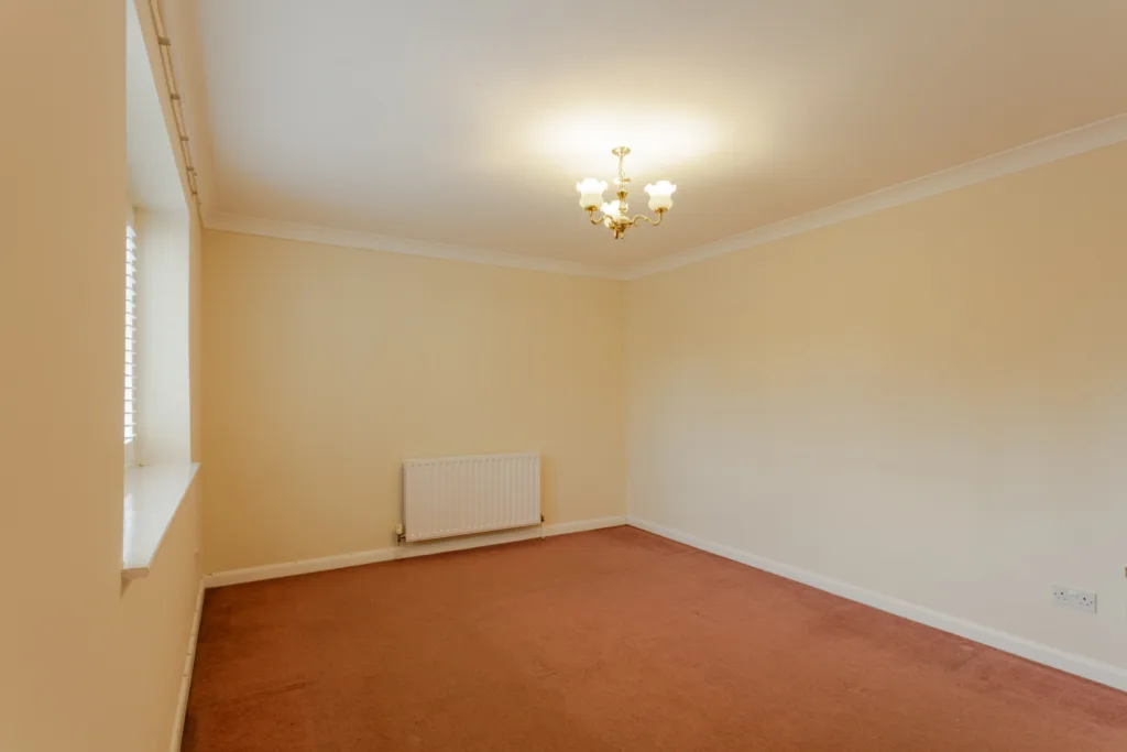 Empty room with beige walls and carpet