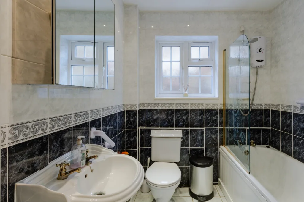 Spacious bathroom with sink, toilet, and bathtub.