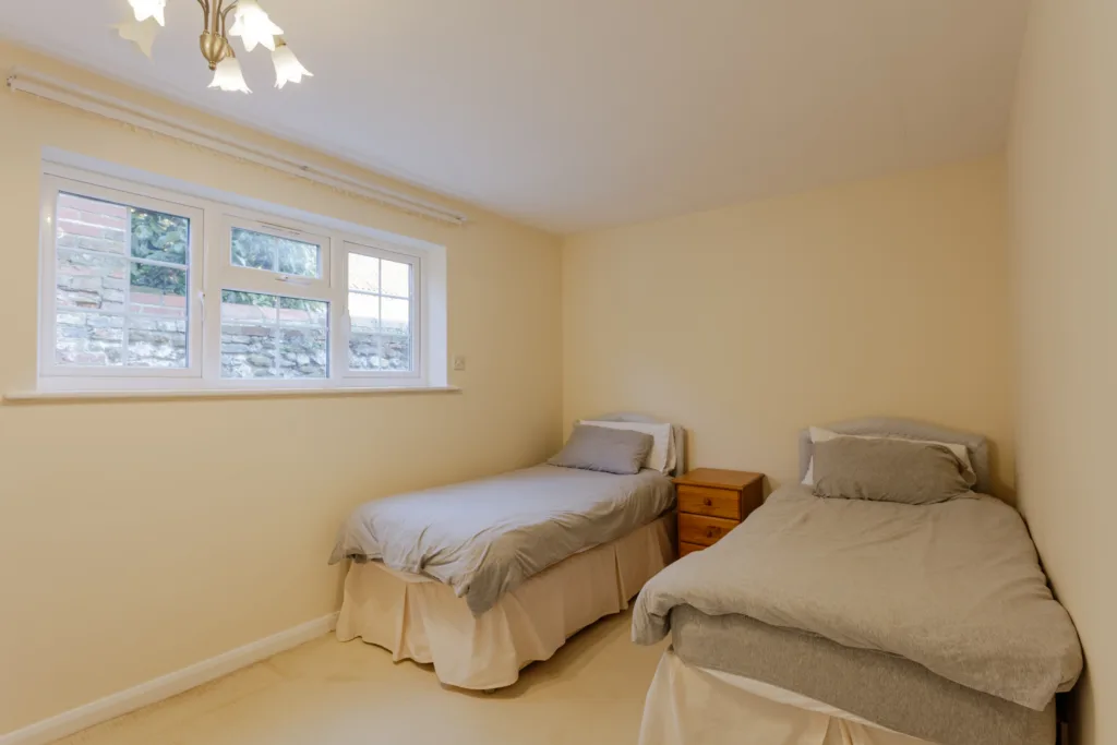 Twin beds in a beige bedroom