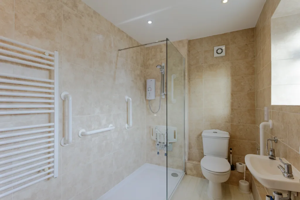 Accessible bathroom with walk-in shower and grab bars.