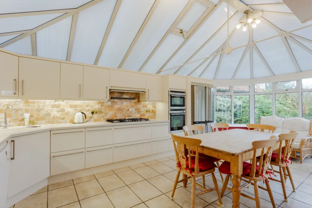 Spacious kitchen with dining area and natural light.