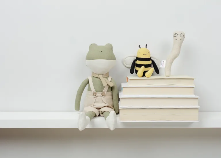 Stuffed toys and books on a shelf
