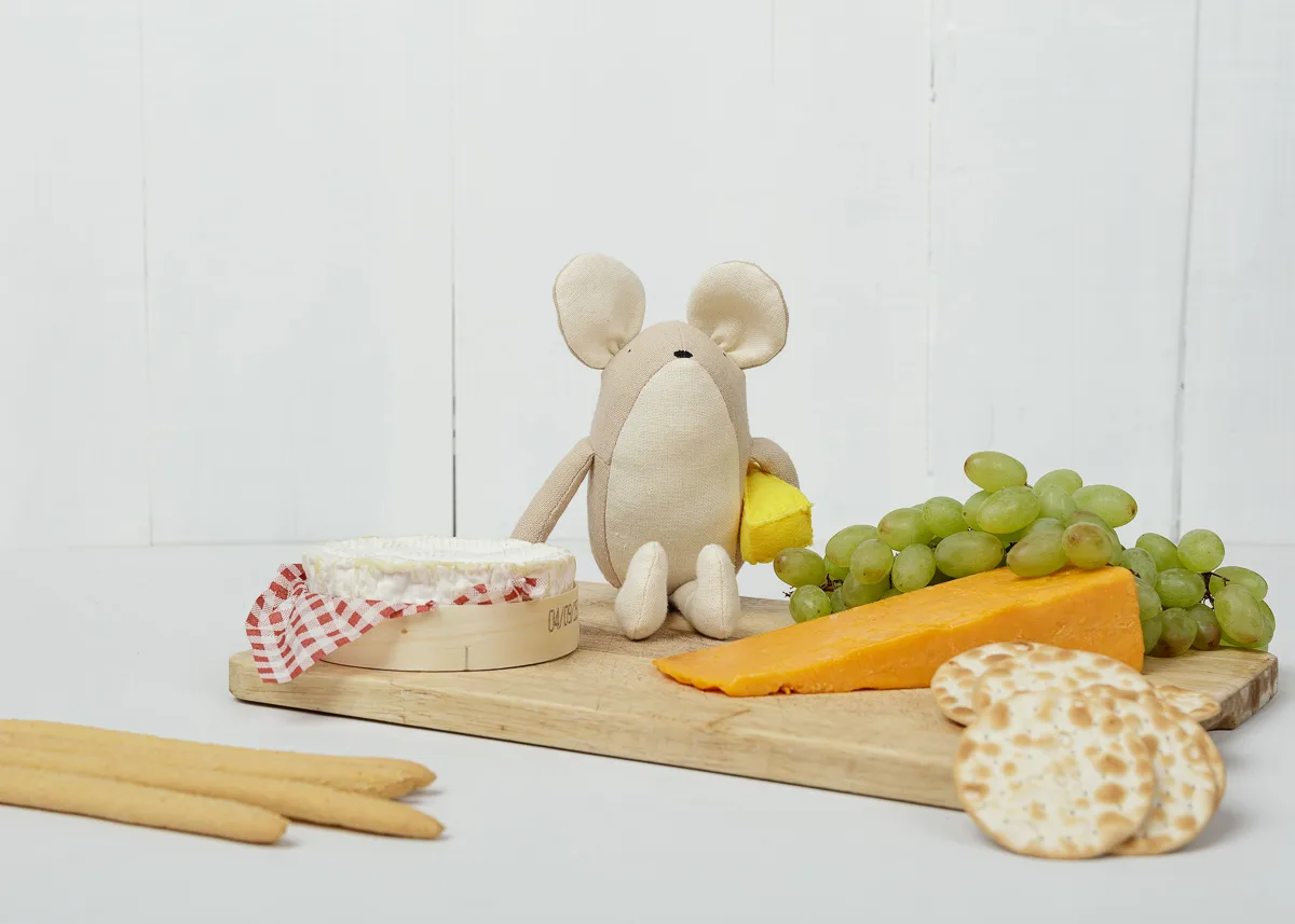 Plush mouse with cheese, grapes, and crackers.