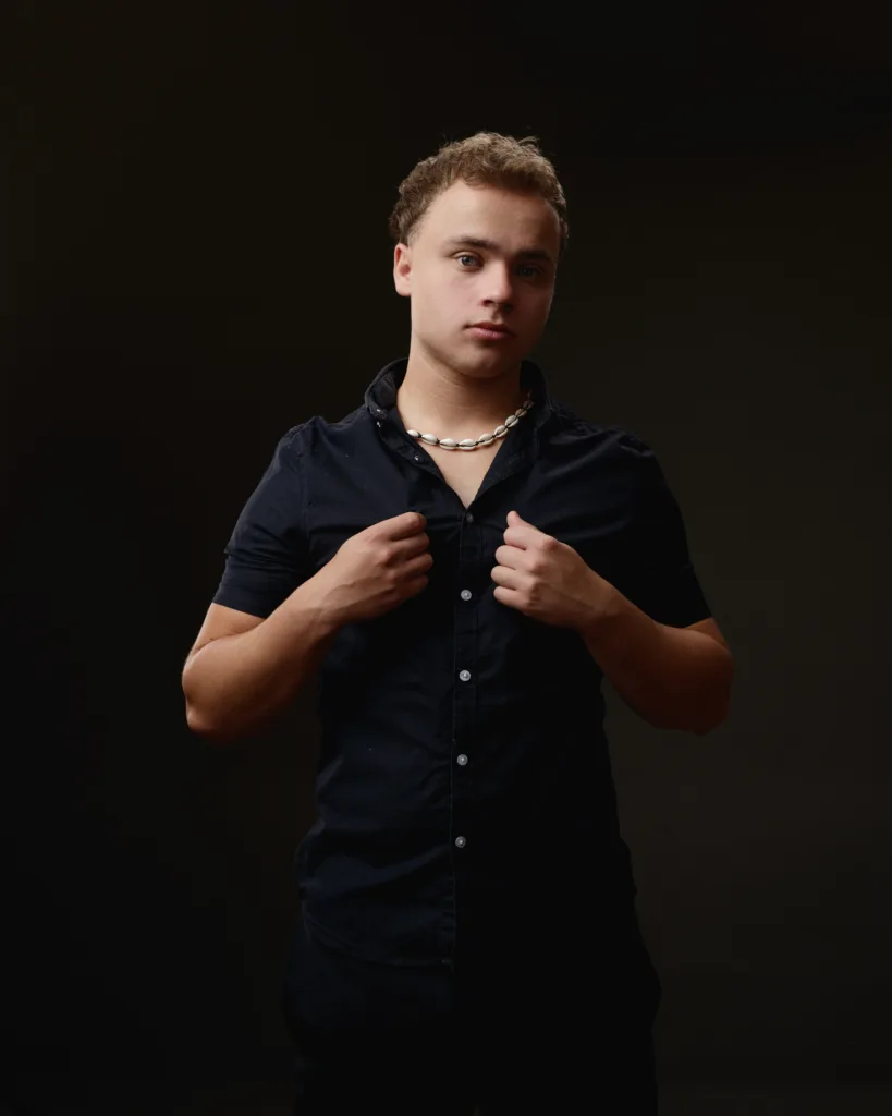 Young man in black shirt, dark background