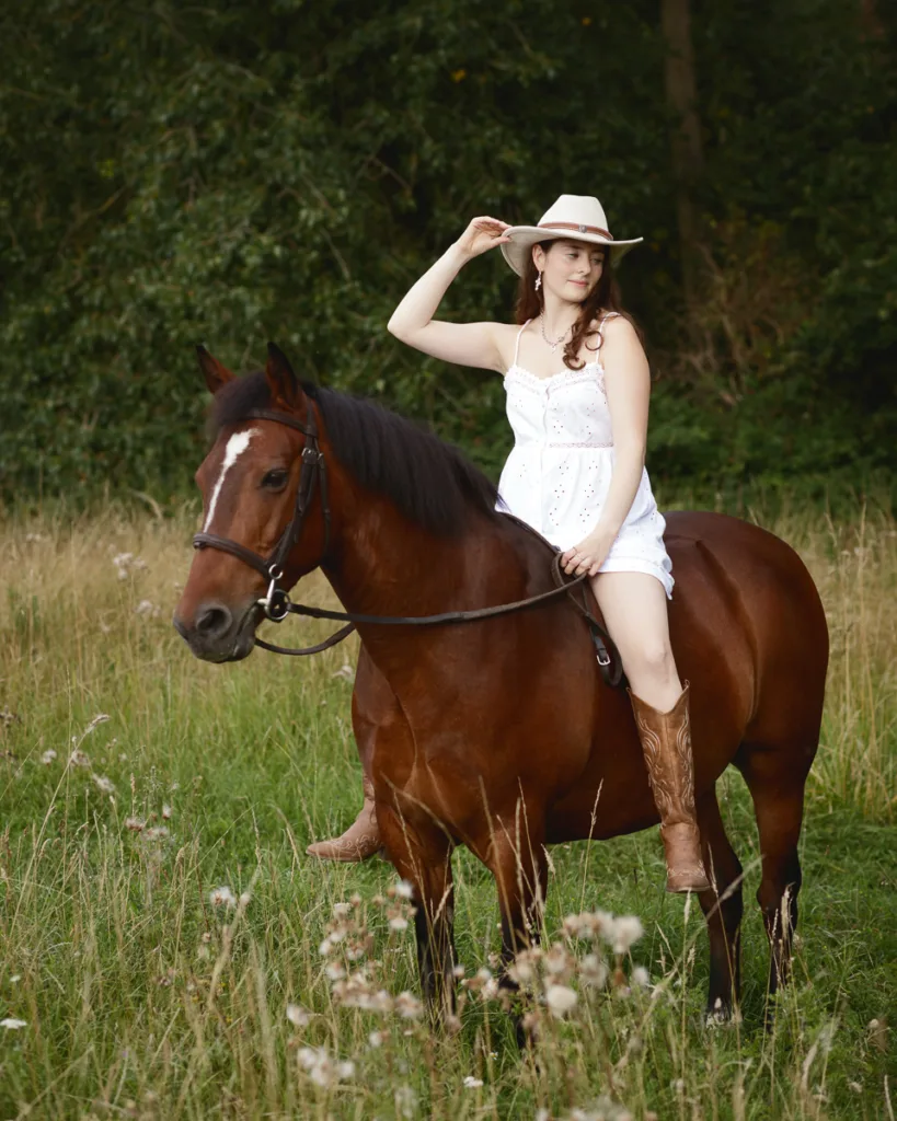 Woman riding horse in a grassy field