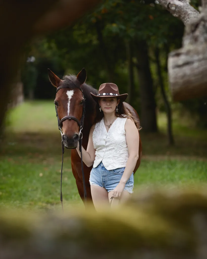 Person in hat with horse outdoors