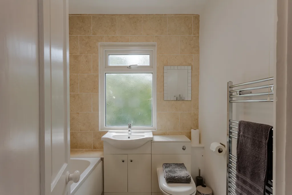 Modern bathroom with tiled walls and window