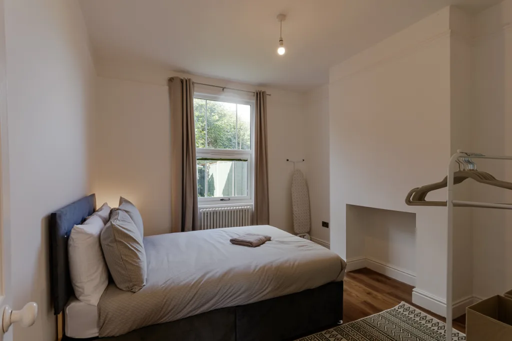 Minimalist bedroom with window and bed.