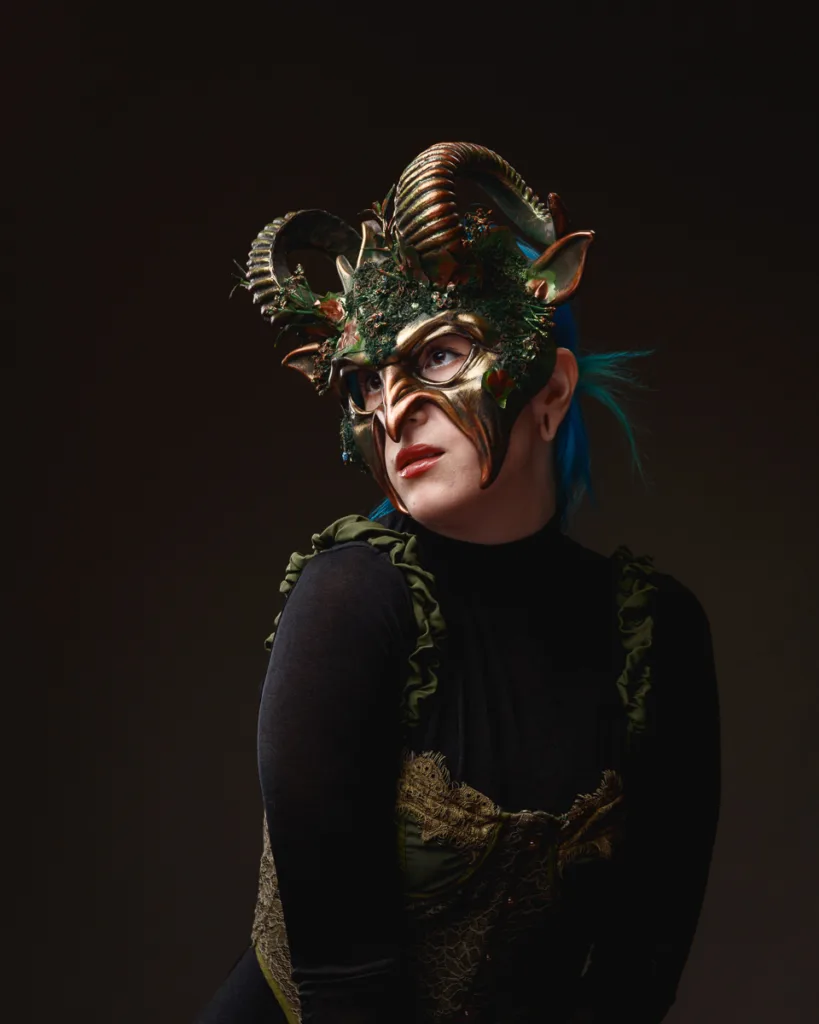 Person in intricate fantasy mask with horns.