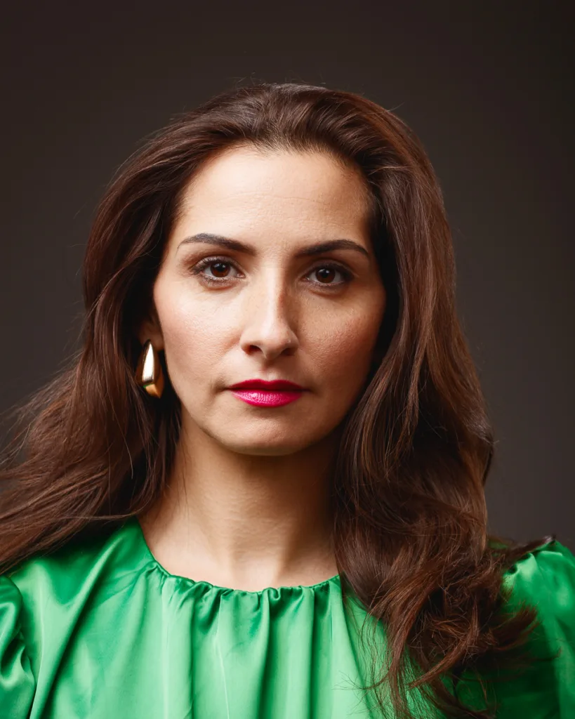 Woman in green blouse with brown hair