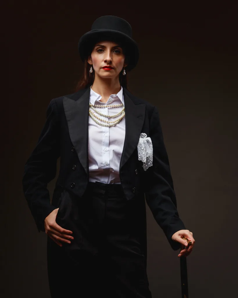 Person in top hat and formal attire.