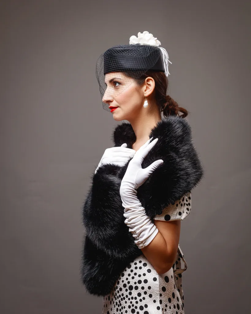 Elegant woman in vintage attire with hat