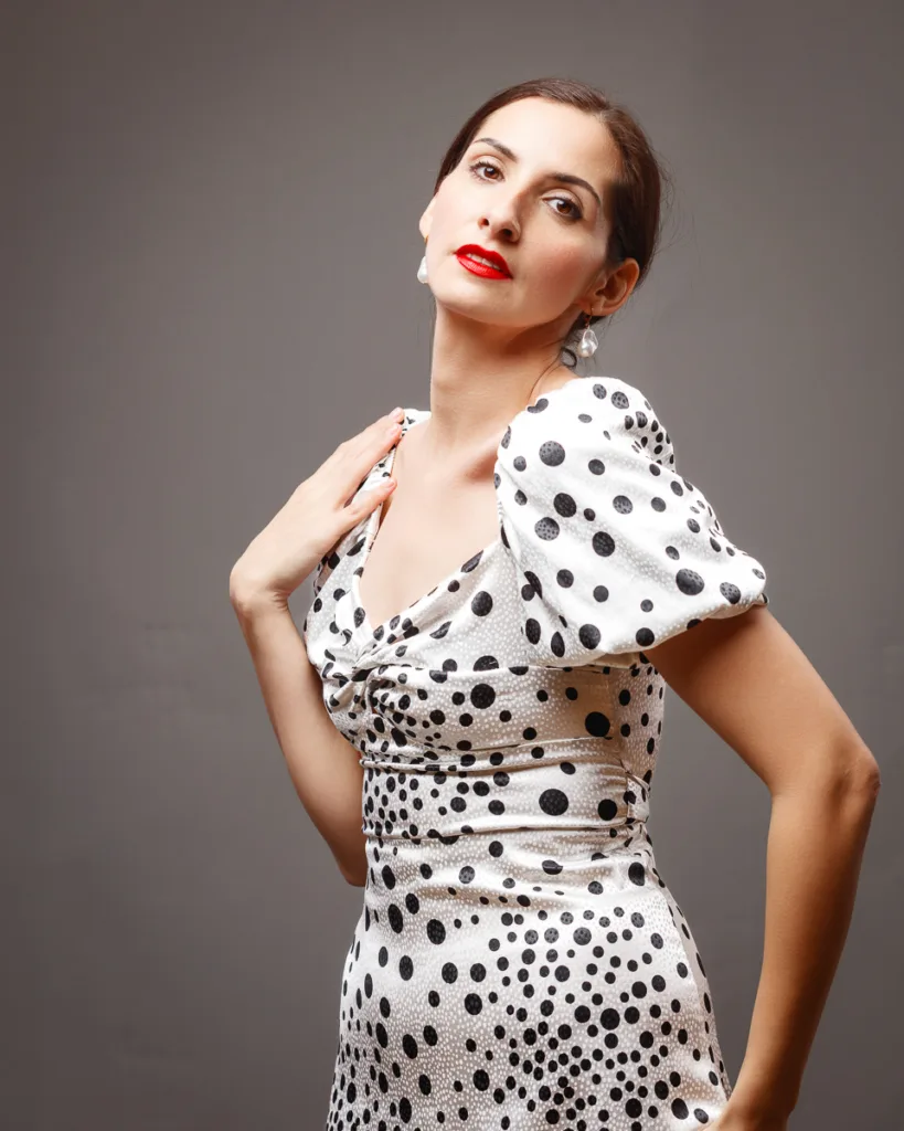 Woman in polka dot dress posing gracefully