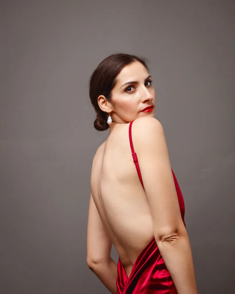 Woman in red dress with open back
