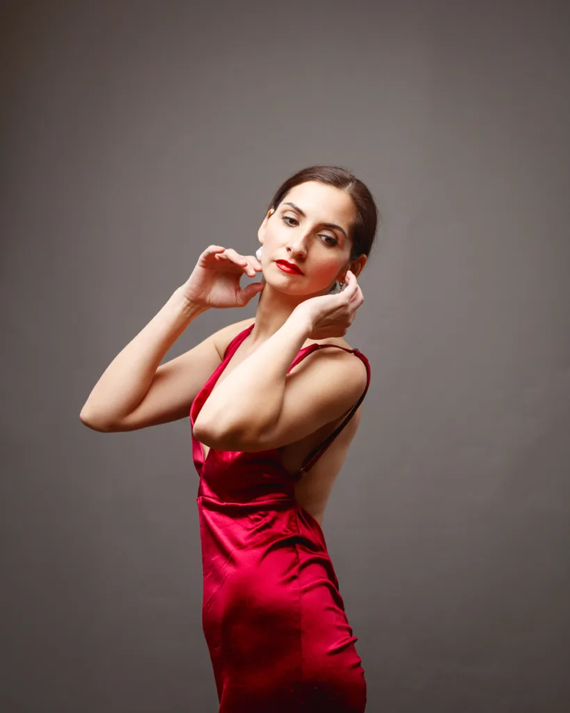 Woman posing gracefully in red dress