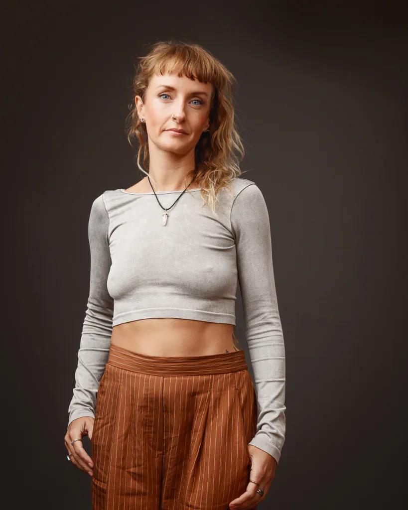 Woman in grey top and brown trousers