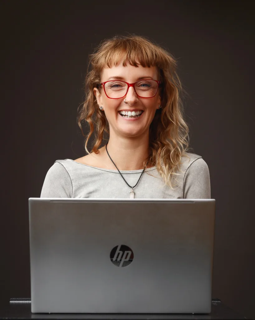 Smiling woman using HP laptop at desk