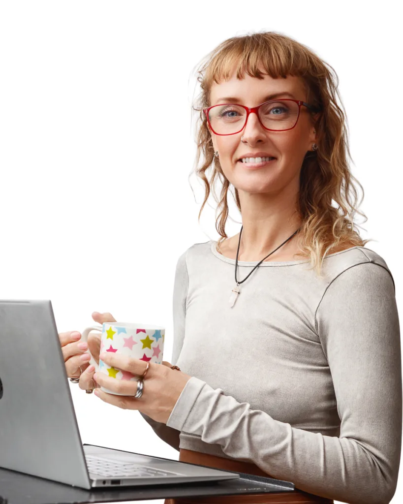 Woman smiling with laptop and star-patterned mug