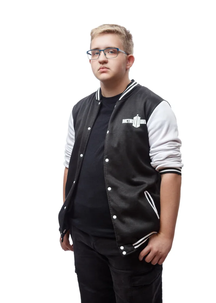 Person wearing Doctor Who jacket and glasses.