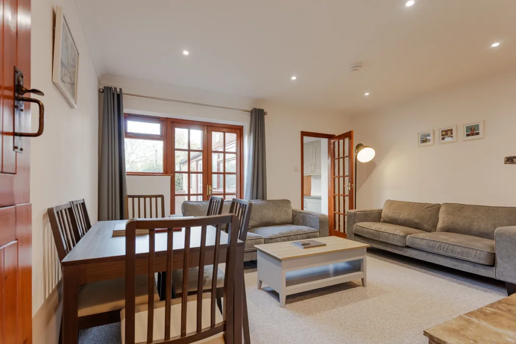 Modern living room with sofas and dining table.